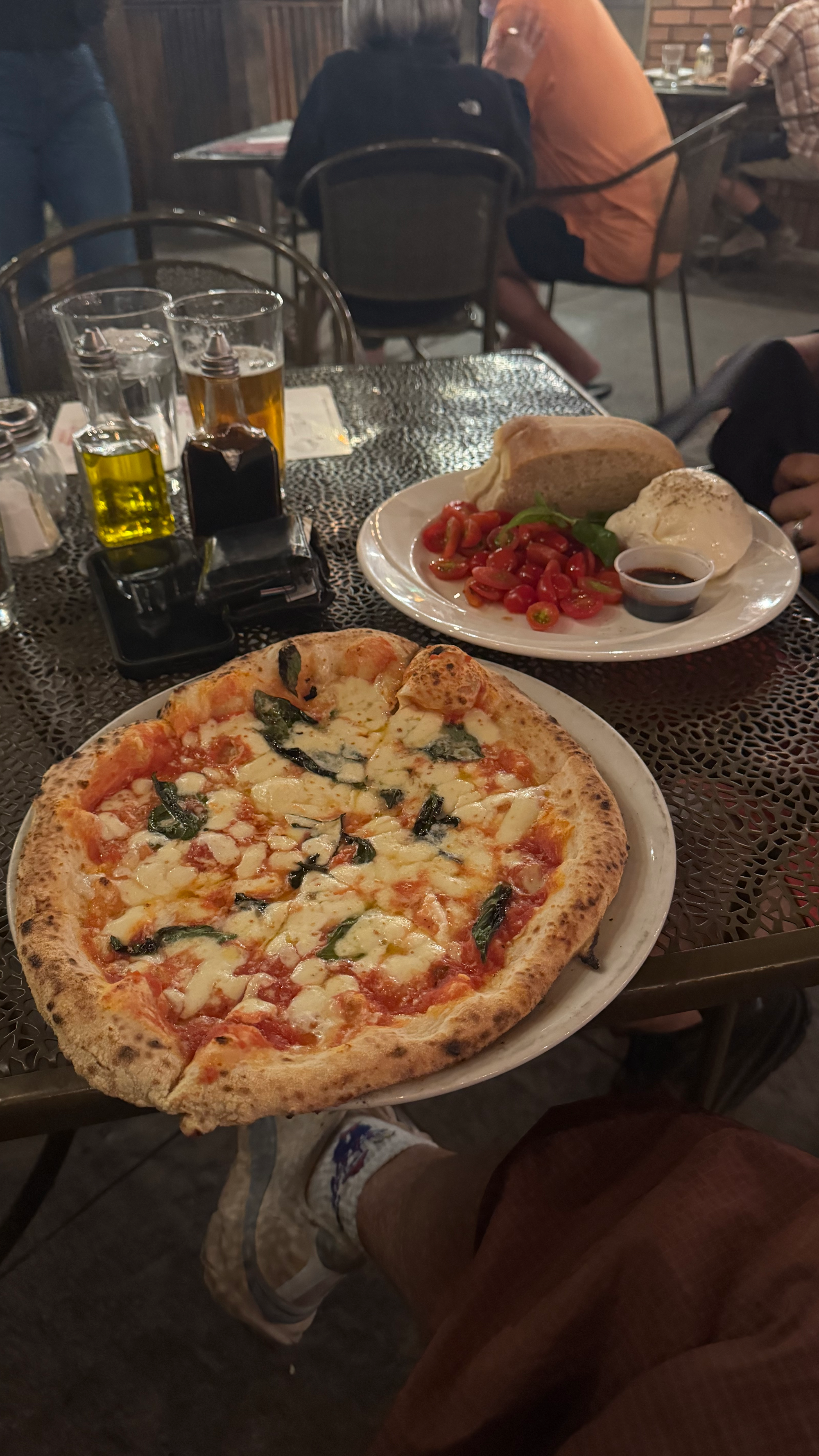 Margherita Pizza and Brushetta appetizer on back patio table at Antica Forma in Moab, Utah