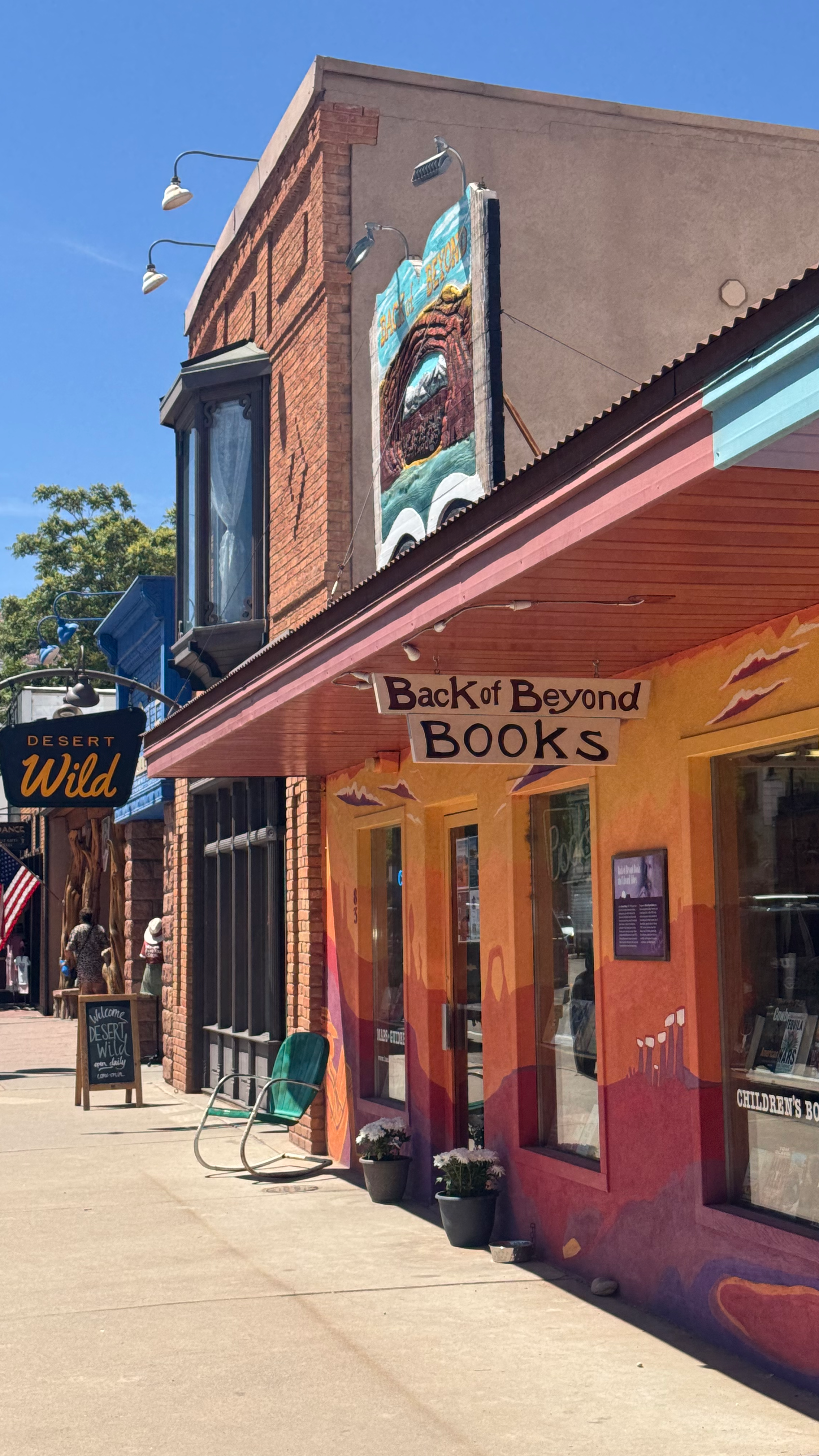 A yellow, orange, red and purple painted building with a sign reading "Back of Beyond Books" in Moab, Utah