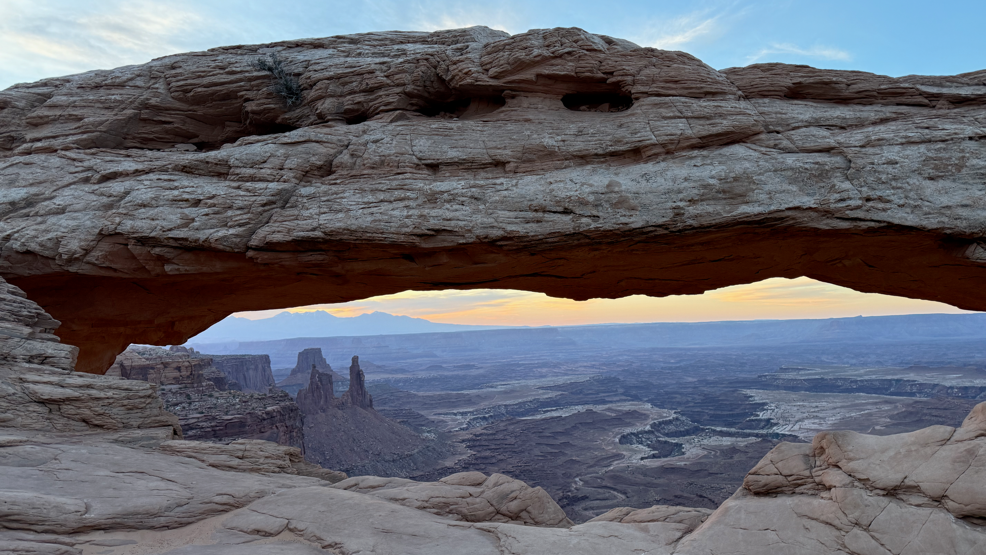 View of Canyonlands National Park through the Mesa Arch at the Mesa Arch Trailhead in Moab, Utah