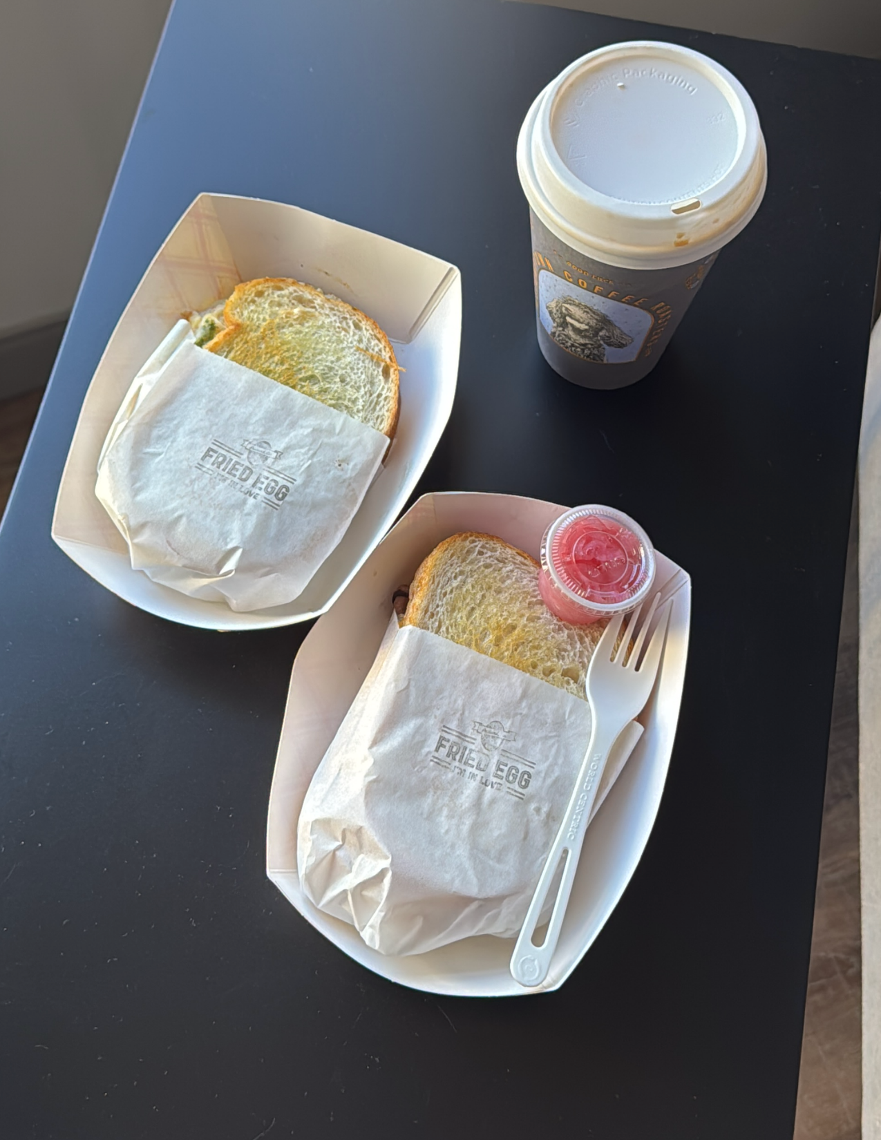 Two breakfast sandwiches from Fried Egg I'm in Love and a cup of Stumptown Coffee in Portland, Oregon
