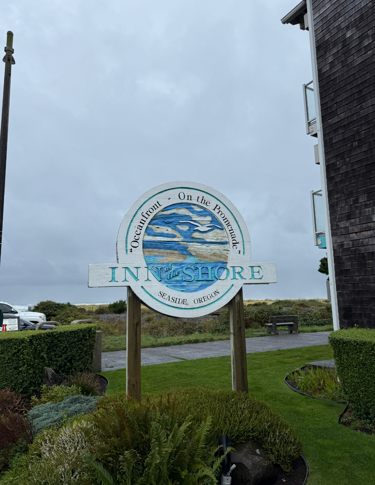Blue and white sign reading "Inn at the Shore Seaside, Oregon" in Seaside, Oregon
