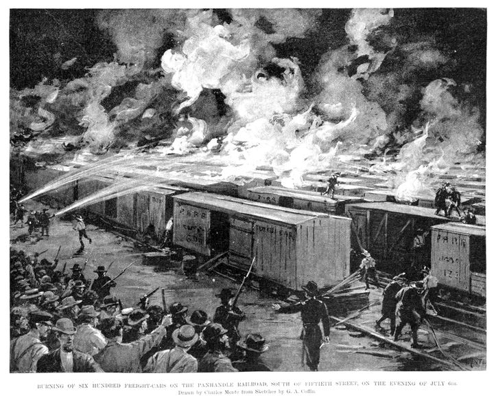 Pullman Strike, 1894: Troops fire into the crowd as freight cars burn.