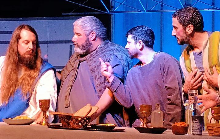 Men with beards sit at a table set up to look like the Last Supper.