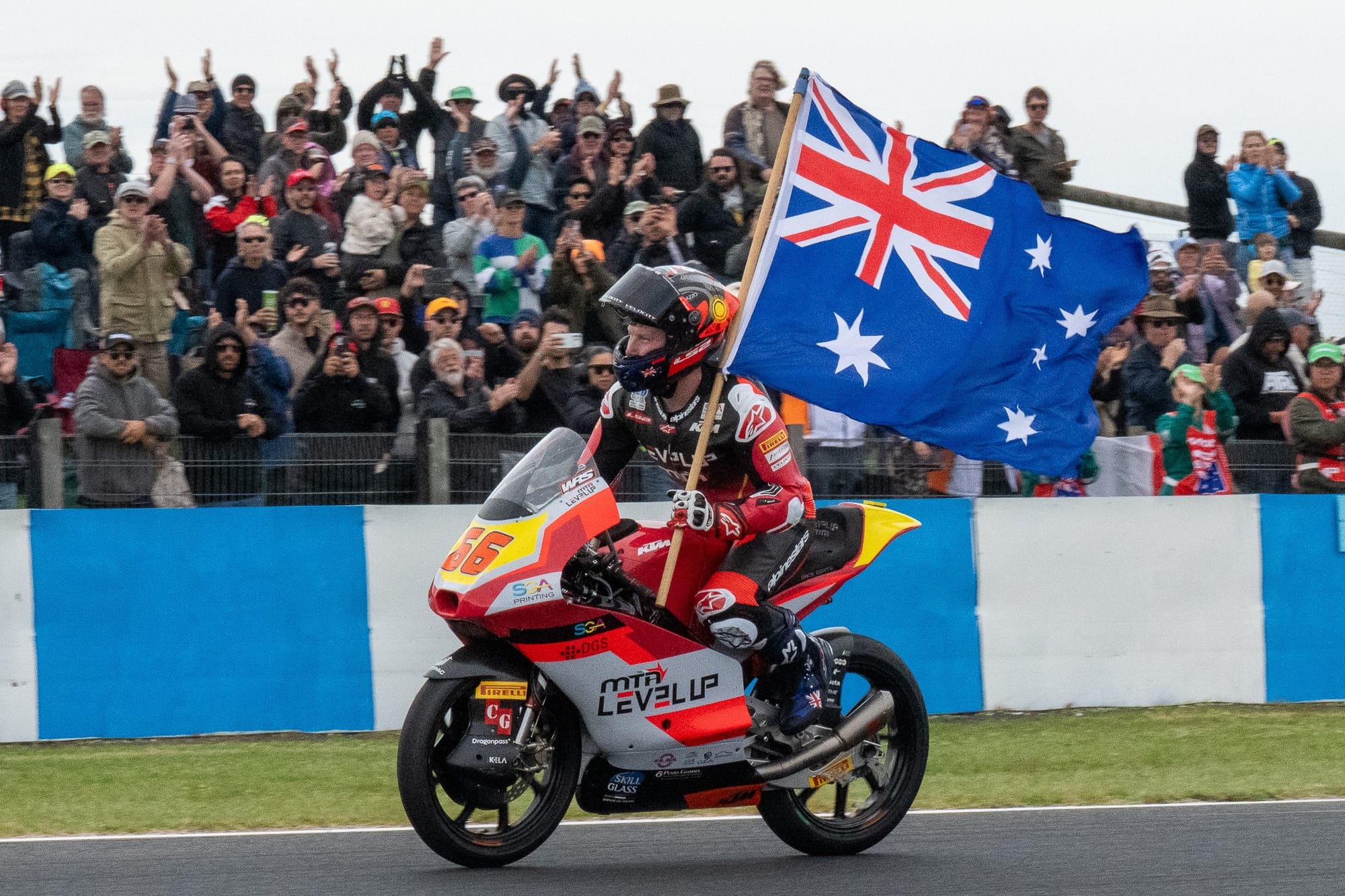 Joel Kelso flying the Australian flag after coming second in the Moto3.  Photo: IanR Photography.