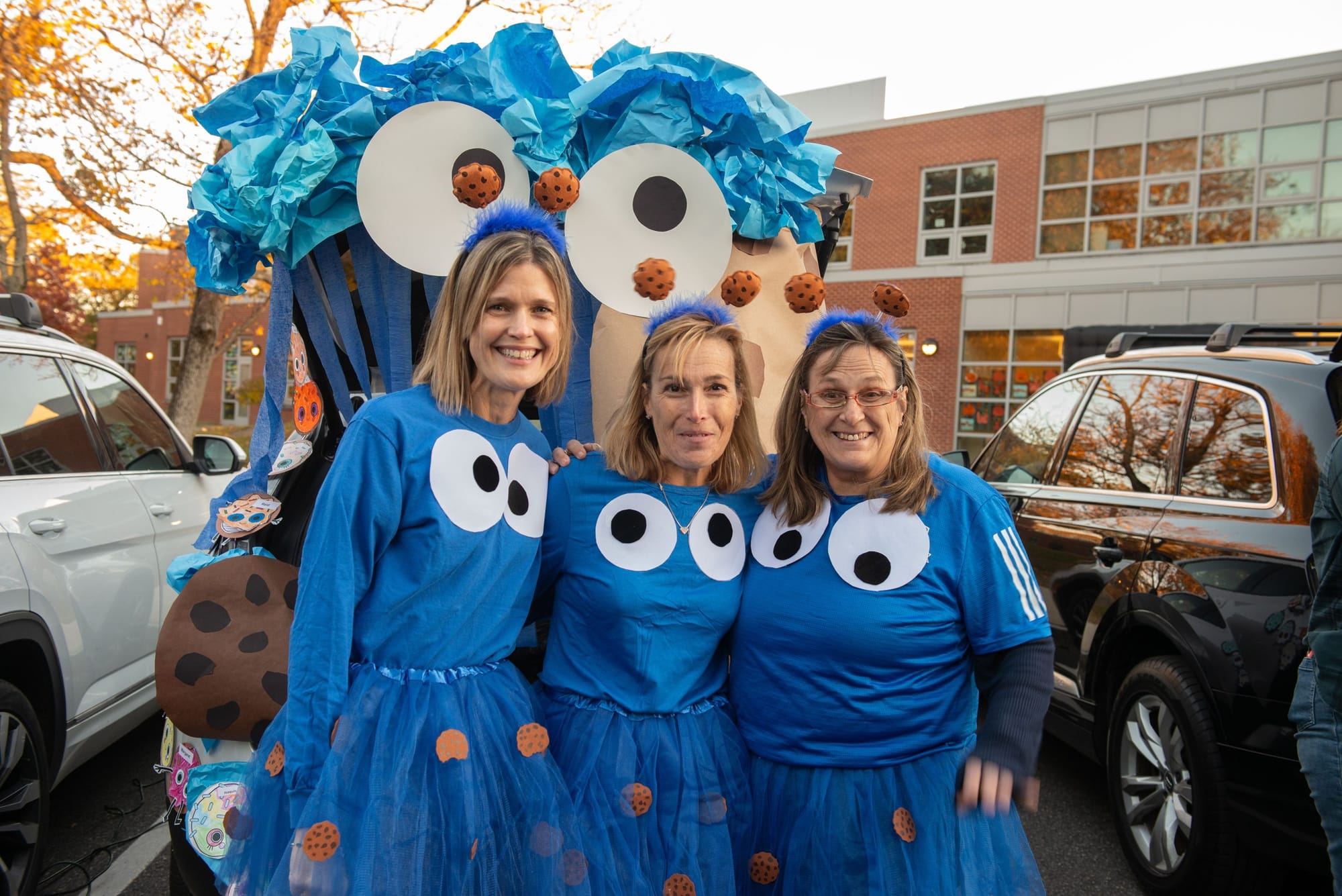 Three Glover School 1st grade teachers dress as Cookie Monster in front of their trunk during the school’s Trunk or Treat.