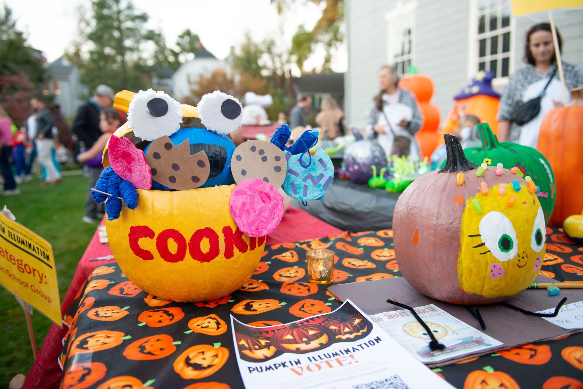 Pumpkin painted and decorated as Cookie Monster on a table of pumpkin entries