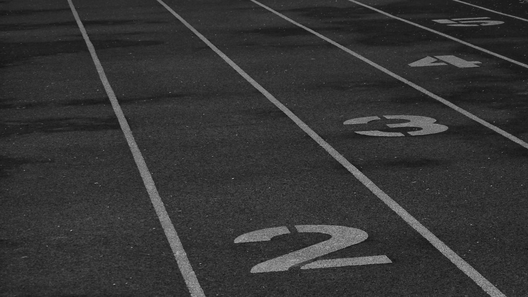 Ground-level view of a standard 400-meter track with white lines