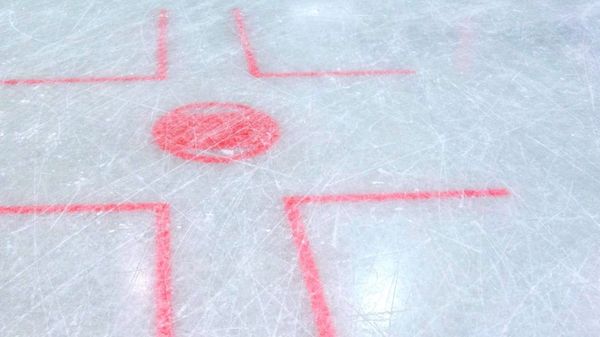 A close-up view of a face off circle on an ice hockey rink.