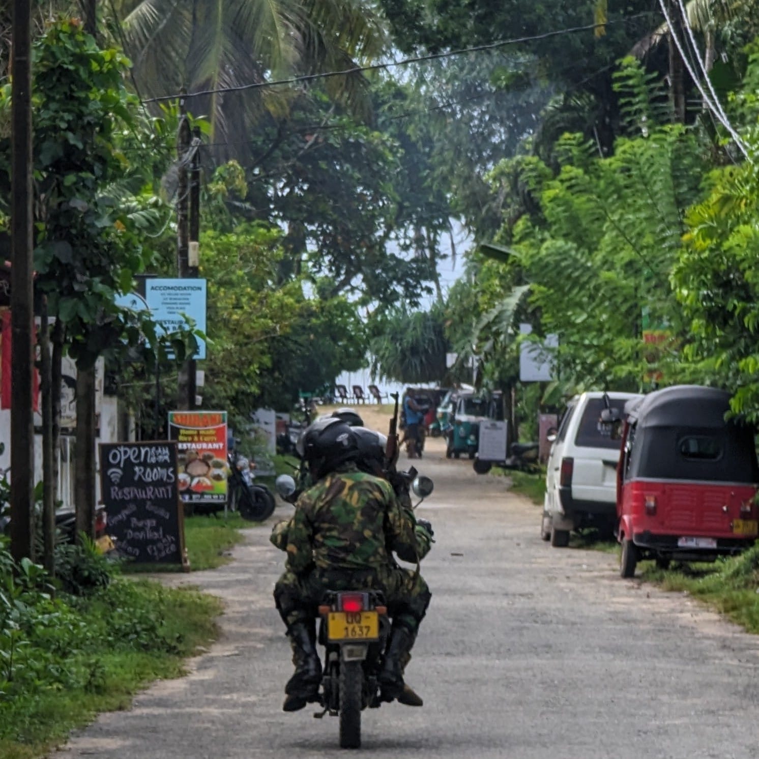A patrol of two motorbikes with AK-47s at the local surf break