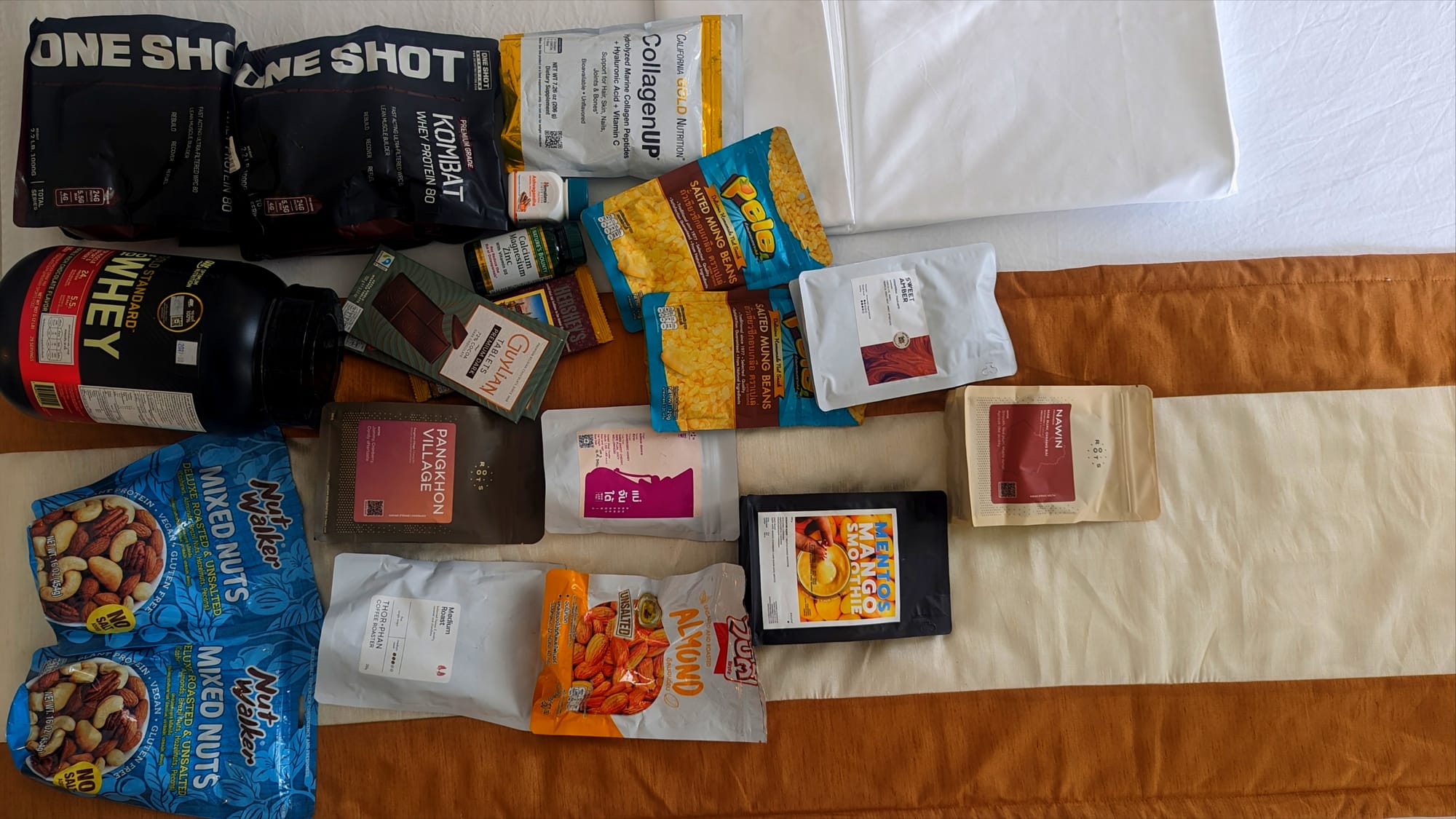 Items that are must-haves to survive as a nomad in Sri Lanka. I planned for a two-month trip: 3kg of whey protein, collagen powder, chocolate, specialty coffee beans, nuts, and vitamins. I wish I had two suitcases to pack!