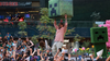 Actor Jason Momoa holding aloft the severed head of a creeper from Minecraft before a braying crowd 