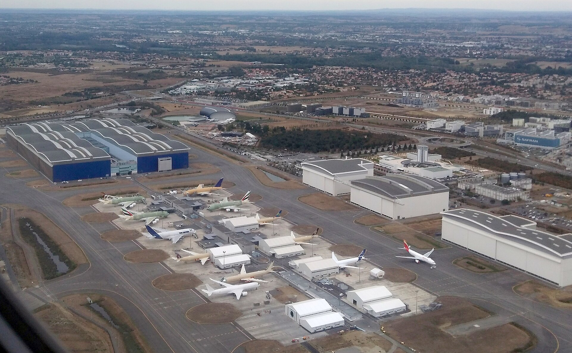 Aerial view of Airbus’s aircraft assembly plant with several wide-body jets
