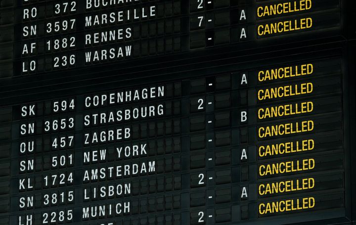 Airport departure board showing multiple cancelled flights.