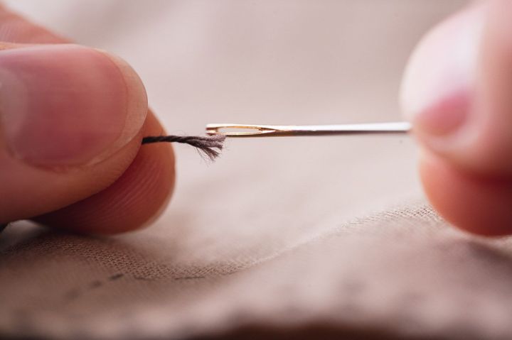 Needle and frayed thread that is wider than the needle's eye.