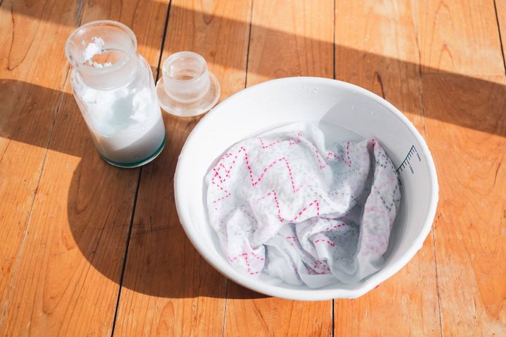 Sashiko kitchen cloth being washed with handmade detergent.