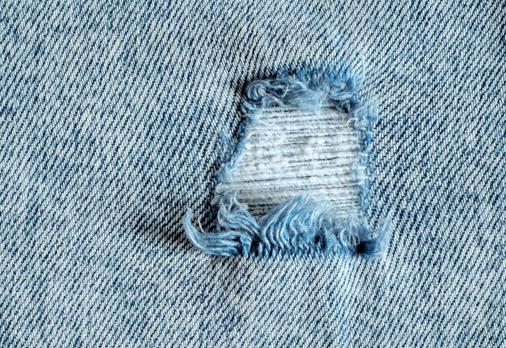 Denims with a hole close up.