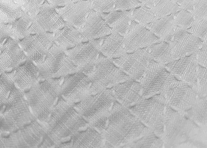 Musubikikkō sashiko pattern stitched in white sashiko thread on white linen