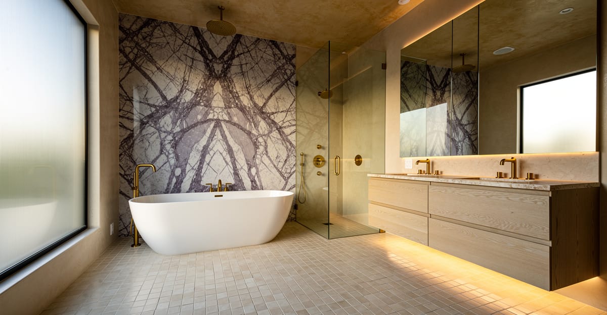 Luxury primary bathroom remodel in San Jose with Calacatta Viola marble walls, unlacquered brass fixtures, and a freestanding soaking tub