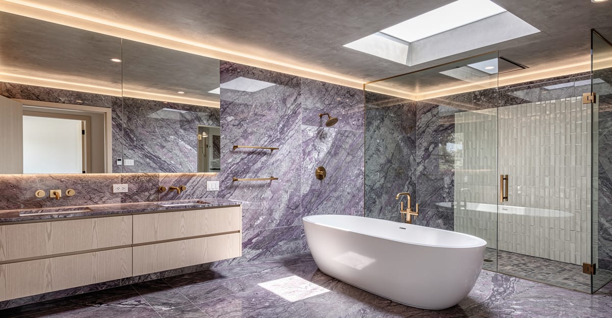 Luxury primary bathroom remodel in Los Altos with Calacatta Viola marble, freestanding soaking tub, and unlacquered brass fixtures