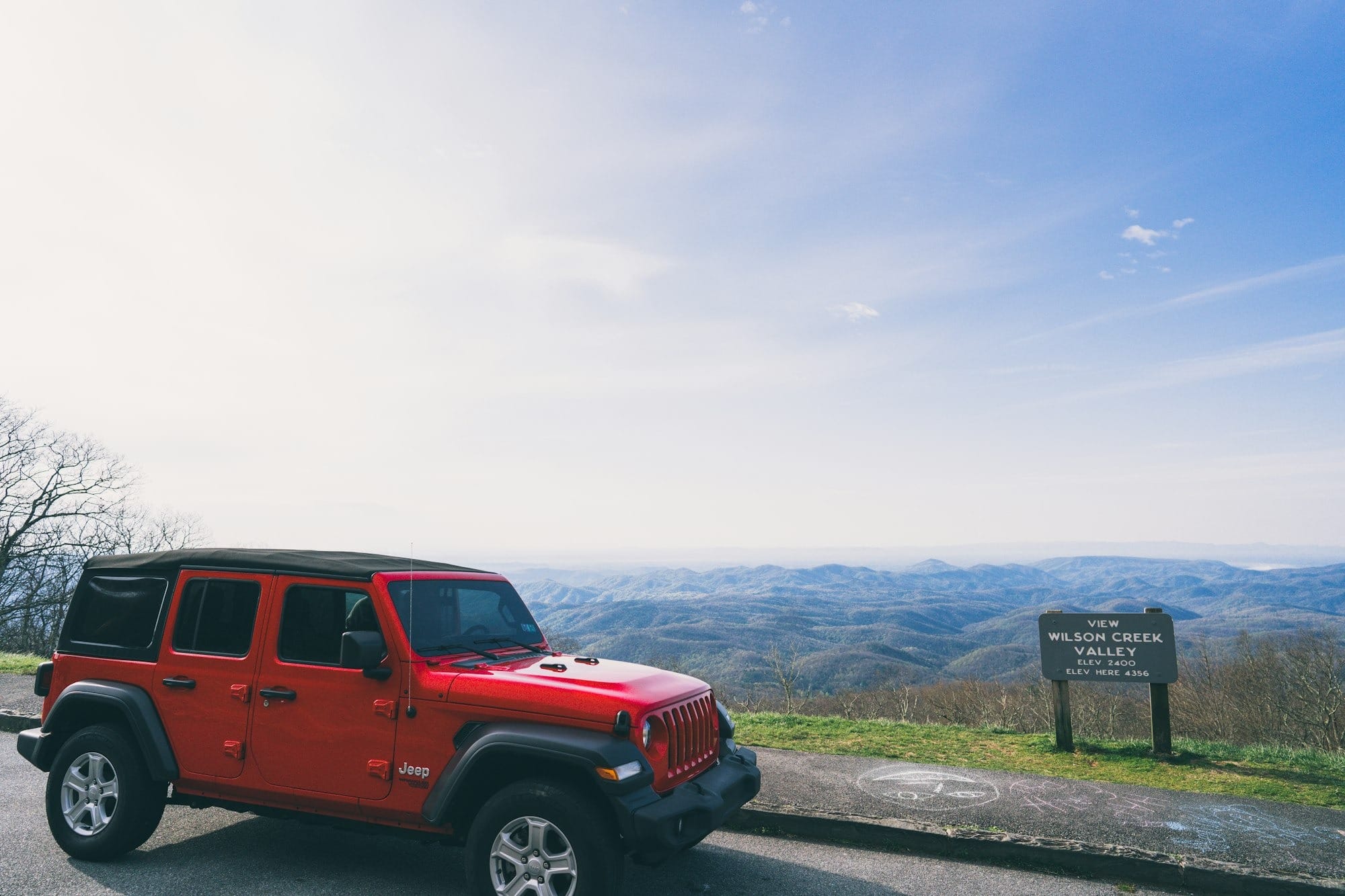 red suv on road during daytime
