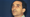 A close-up portrait photograph of Arun Shourie, looking slightly upward against a plain dark blue background. 