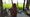 A photo of a woman shot from behind, overlooking agricultural fields. She is a Bangladeshi Hindu migrant woman in Jharkali, W