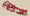An illustrated outline map of Nepal in red against a beige background depicting four architects Louis I Kahn, Rem Koolhaas, T