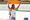 Deepthi Jeevanji, an Indian para-athlete with long black hair pulled back holds the Indian flag high with both her hands