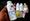 A hand holds a bottle of Johnson’s baby powder in the foreground, with several other Johnson’s baby care products blurred in 