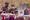 Composite image of Myanmar military junta looming over an electronic voting machine with election posters on the top right, a