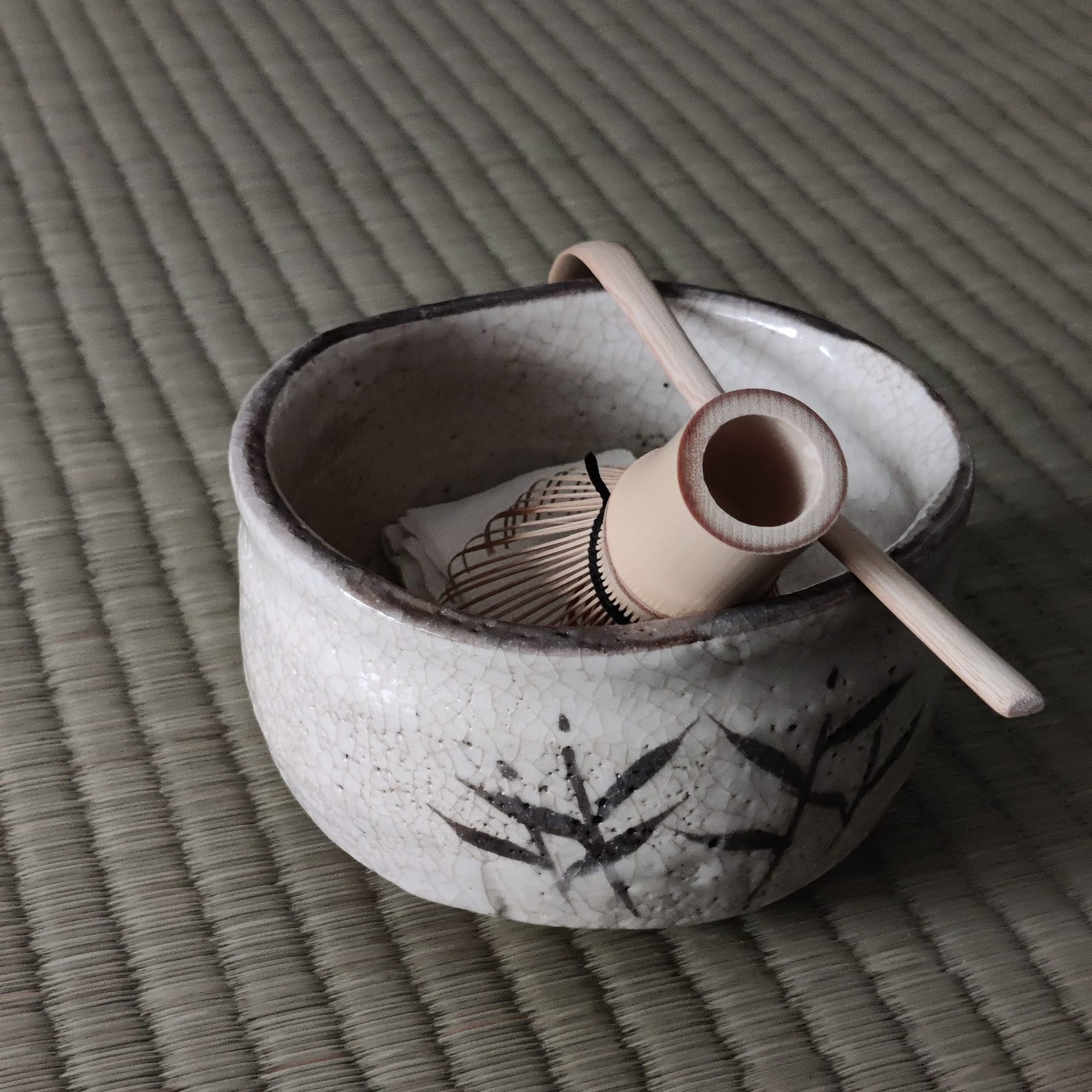 Chawan with chasen, chashaku and chakin on tatami mat. Photo credit: Jan Chan @janschanoma