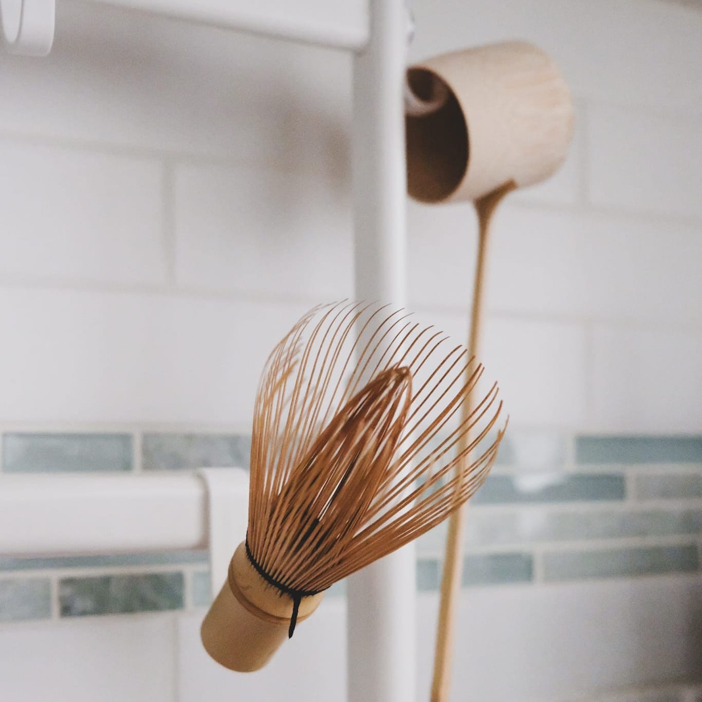 A chasen (bamboo whisk) hanging on a hook to dry. Photo credit @janschanoma