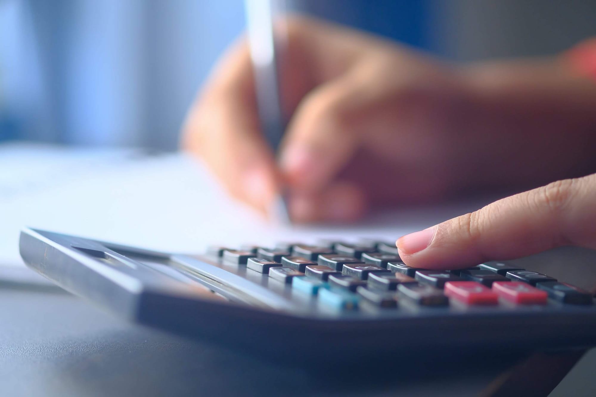 Close-up photo of a hand using a calculator