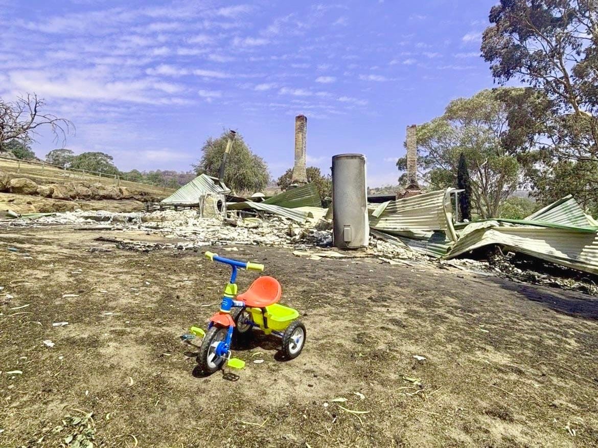 A farmer returns to ashes and  charred landscapes