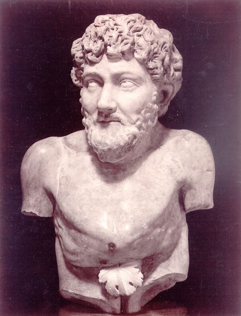 Photo of a marble bust of a bearded, curly-haired man