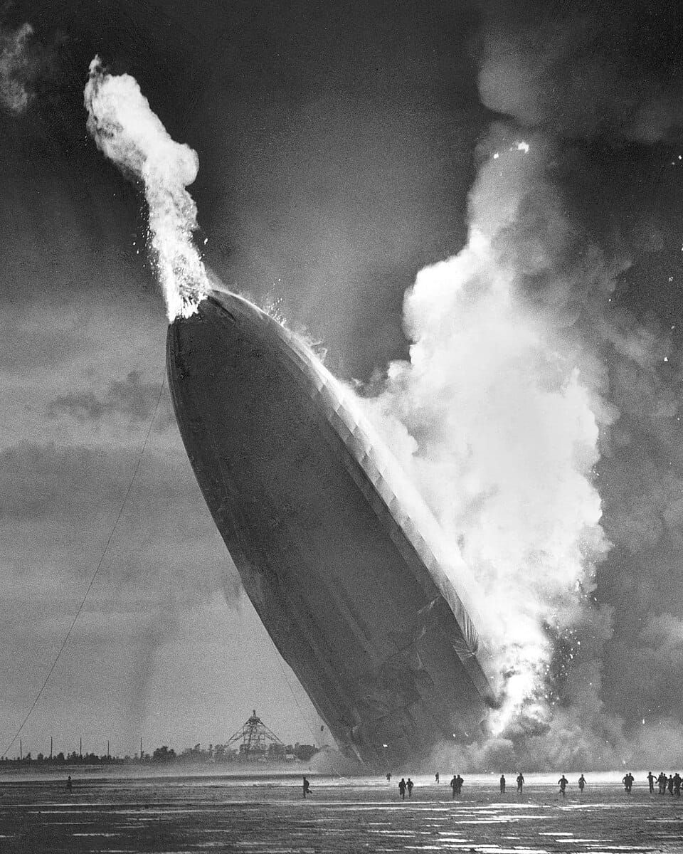 B&W photo of a burning dirigible crashing into the ground