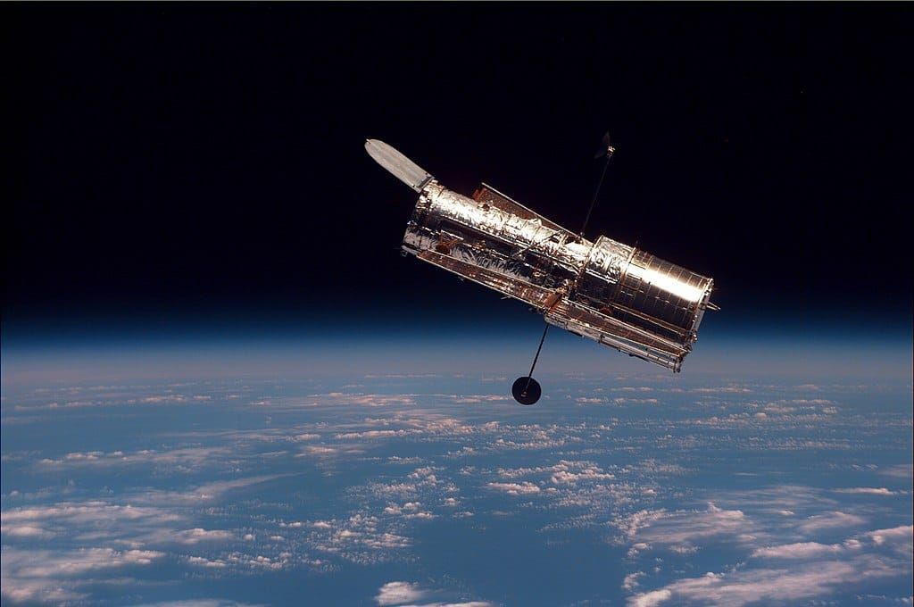 Photo of a satellite in orbit above the Earth