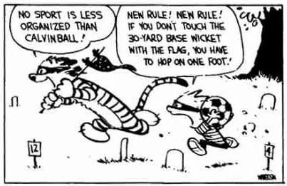 Comic of a masked boy holding a soccer ball chasing a masked, flag-holding tiger around croquet wickets and numbered posts