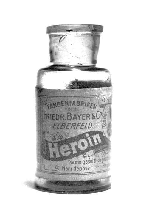 B&W photo of a Bayer medicine bottle labeled “Heroin”