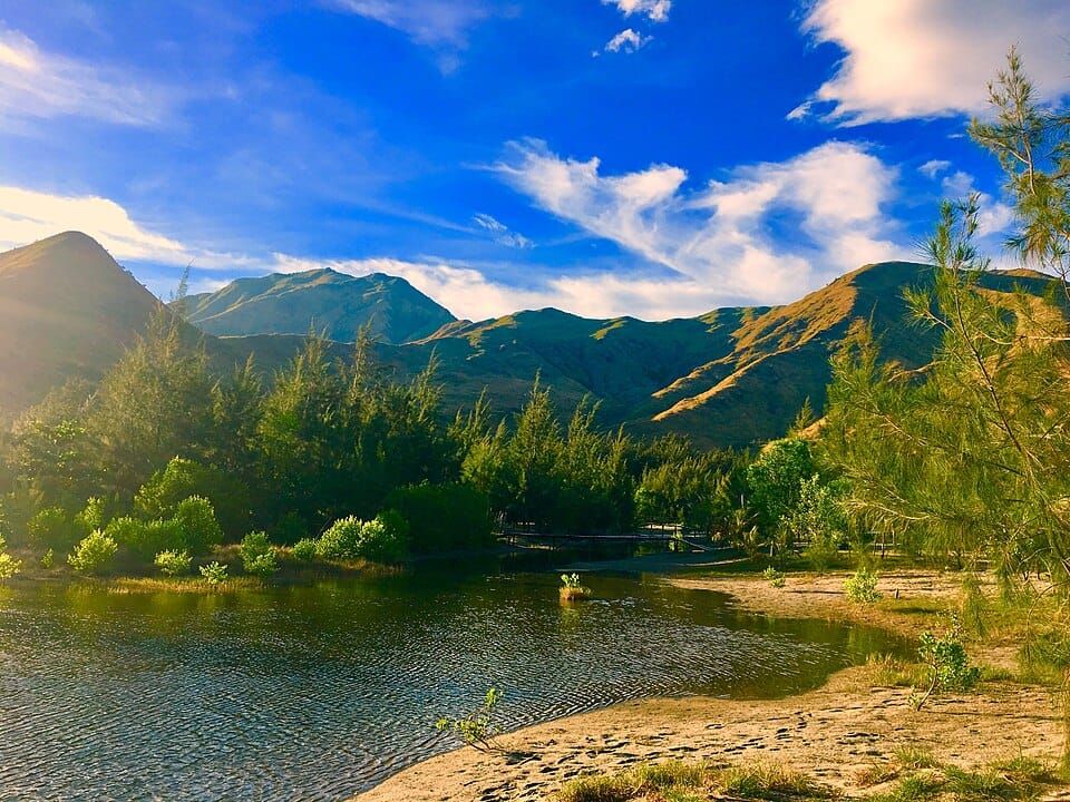 Photo of an isolated cove with mountains in the background