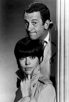 B&W photo of a man and a woman in trench coats