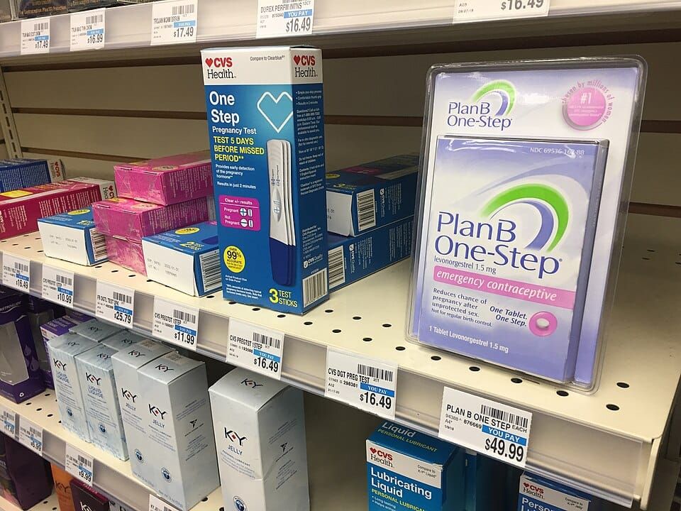 Photo of a pharmacy shelf stocking contraception, pregnancy tests, and lubricants