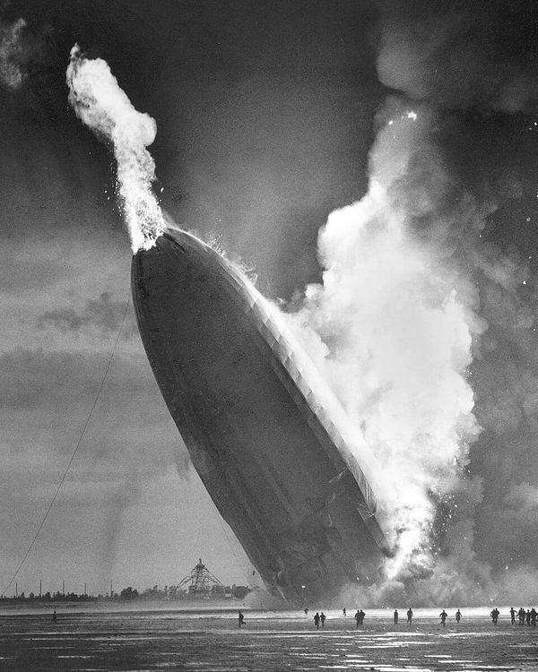 B&W photo of a burning dirigible crashing into the ground