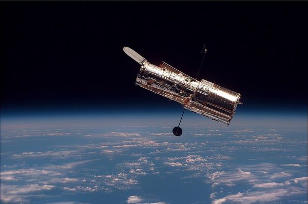 Photo of a satellite in orbit above the Earth