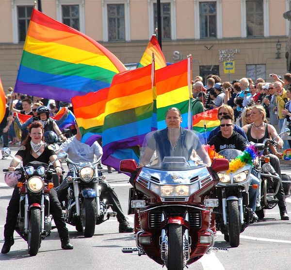 Photo of a group of women on motorcycles with rainbow, pride flags
