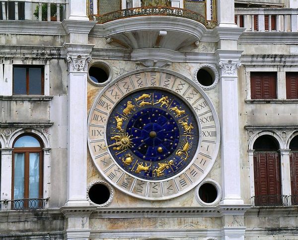 Photo of a clockface bearing astrological symbols
