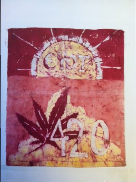 Batik-dyed flag bearing the words “Eyot 420” and a cannabis leaf
