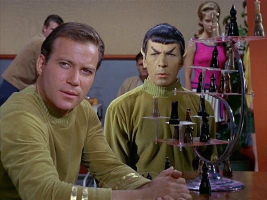 Screenshot of Capt. Kirk & Mr. Spock next to a 3-D chess board in the TV series Star Trek