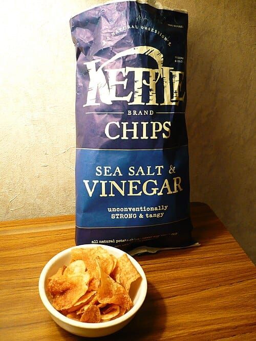 Photo of a bag and bowl of Kettle Foods-brand sea salt & vinegar potato chips/crisps