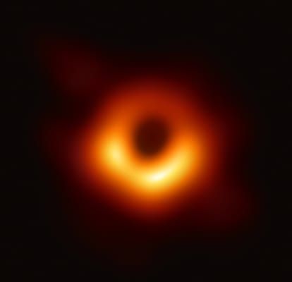 Photo of a dark circle surrounded by a bright, orange ring